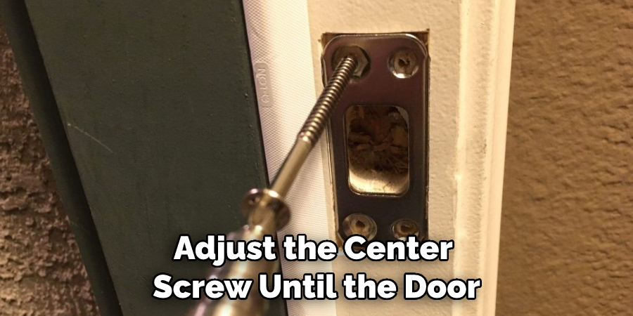 Adjust the Center Screw Until the Door