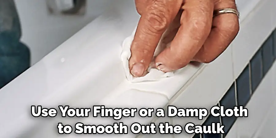 Use Your Finger or a Damp Cloth to Smooth Out the Caulk