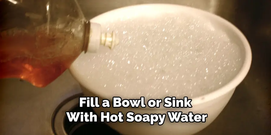 Fill a Bowl or Sink With Hot Soapy Water