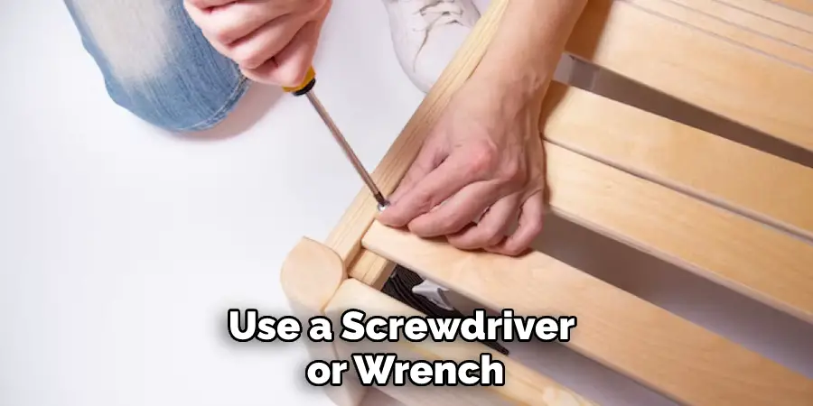 Use a Screwdriver or Wrench
