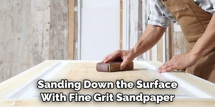 Sanding Down the Surface With Fine Grit Sandpaper