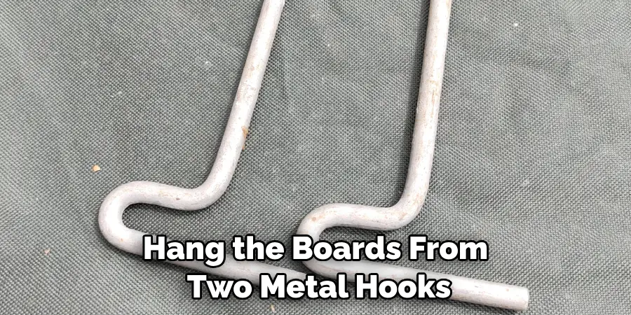 Hang the Boards From Two Metal Hooks