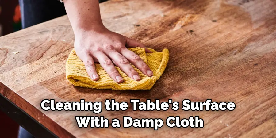 Cleaning the Table's Surface With a Damp Cloth
