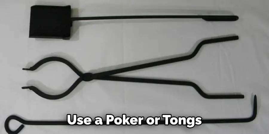 Use a Poker or Tongs