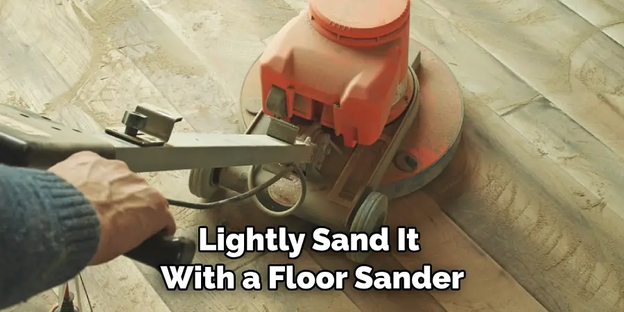 lightly sand it with a floor sander