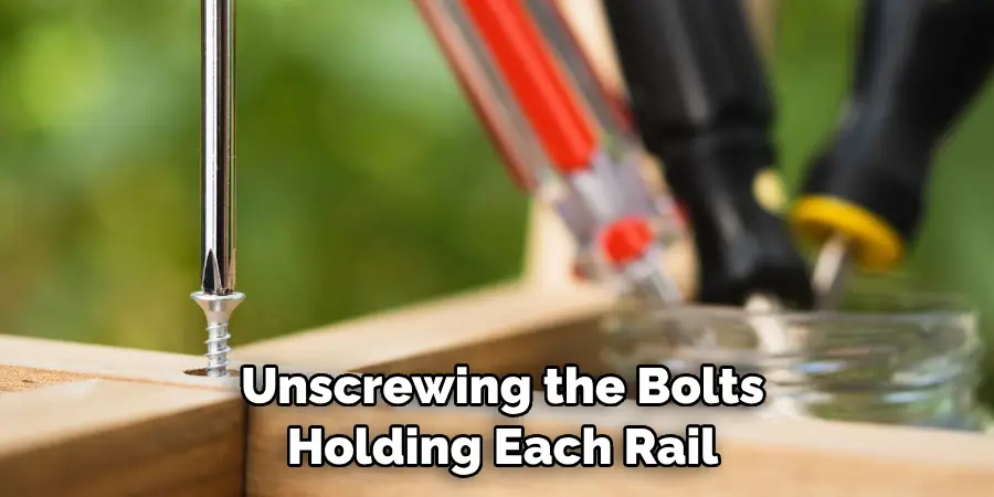  Unscrewing the Bolts Holding Each Rail