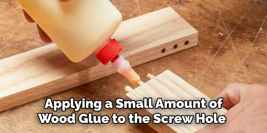 Applying a Small Amount of Wood Glue to the Screw Hole 